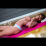 Adeline busty sex doll from MyRealDolls featuring realistic facial features, long hair, and detailed body contours.
