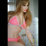 Realistic Jenna sex doll by MyRealDolls featuring detailed facial features, blonde hair, and lifelike body contours.