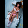 MyRealDolls Kai Naughty Sex Doll showcasing realistic head, detailed facial features, and life-like body in a seated pose.