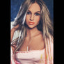 Realistic Kelly Sweet sex doll from MyRealDolls with detailed facial features, blonde hair, and life-like body in a natural pose.