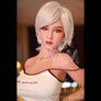 Violette tall-busty sex doll by MyRealDolls with realistic facial features and detailed body, shown in a life-like pose.